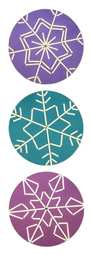 Three snowflakes made with lollipop sticks